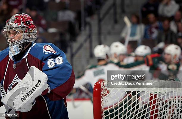 Goaltender Jose Theodore of the Colorado Avalanche looks on as the Minnesota Wild celebrate a second period goal by Aaron Voros during Game Six of...