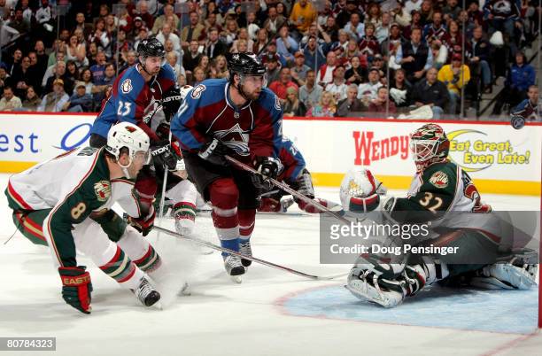 Peter Forsberg of the Colorado Avalanche bounces a shot wide off the post as goaltender Niklas Backstrom of the Minnesota Wild defends during Game...