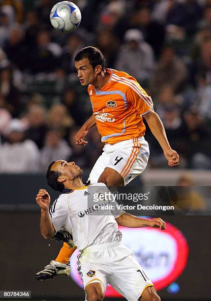 Patrick Ianni of the Houston Dynamo heads the ball over Landon Donovan of the Los Angeles Galaxy in the second half during their MLS game at the Home...