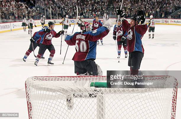 Goaltender Jose Theodore and Adam Foote and the Colorado Avalanche celebrate after defeating the Minnesota Wild during Game Six of the 2008 NHL...
