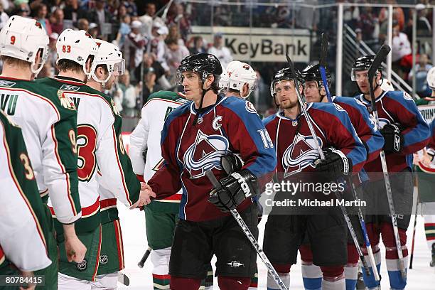 Joe Sakic and other members of the Colorado Avalanche shake hands with the Minnesota Wild after the victory in game six of the Western Conference...