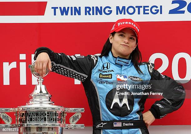 Danica Patrick driver of the Motorola Andretti Green Racing Honda Dallara poses with the trophy after winning the IndyCar Series Bridgestone Indy...