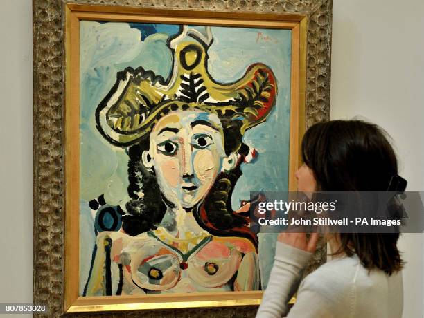 Mary Engelhart studies Picasso's Femme au Grand Chapeau Buste which is estimated value of $8/12 million, at the Sotheby's showroom in New Bond Street...