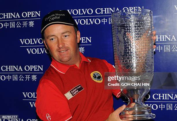 Ireland's Damien McGrane lifts the trophy for the maiden win of his career at the China Open in Beijing on April 20, 2008. McGrane scored a...