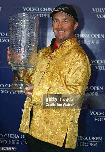 Damien McGrane of Ireland celebrates with the trophy after winning the final round of the Volvo China Open at the Beijing CBD International Golf Club...