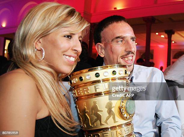 Bayern Munich's French midfielder Franck Ribery and his wife Wahiba Ribery pose with the German Cup trophy, on early April 20, 2008 during the Bayern...