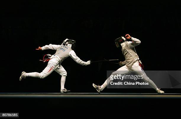 Ota Yuki of Japan fights with Cheremisinov Alexey of Russia during their quarterfinal match in Men's Individual Foil at the "Good Luck Beijing" 2008...
