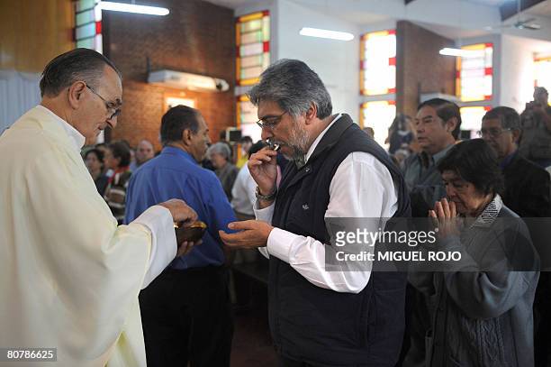 Paraguayan former Catholic bishop Fernando Lugo, presidential candidate of the Alianza Patriotica para el Cambio party, takes communion during a mass...