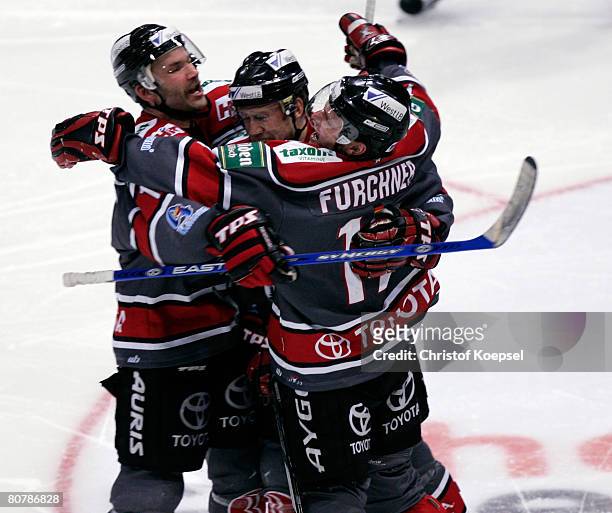 Sebastian Furchner of the Haie celebrates his first goal with Mirko Luedemann and Daniel Rudslaett during the DEL Play-Offs final match between...
