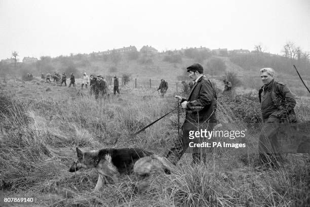 Searchers with tracker dogs search the countryside at Sedgley, near Dudley in Worcestershire for the kidnapped heiress Lesley Whittle.