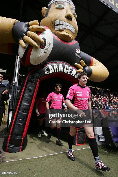 Adam Powell of Saracens walks out onto the pitch wearing a shirt supporting Breast Cancer Care and a pair of pink Nike boots during the Guinness...