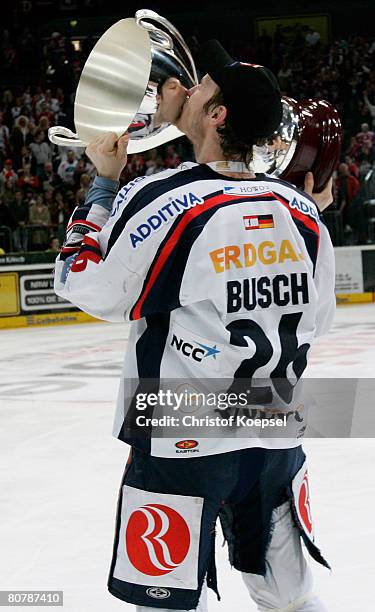 Florian Busch of the Eisbaeren Berlin kisses the trophy after winning 2-1 the DEL Play-Offs final match against Koelner Haie at the Cologne Arena on...