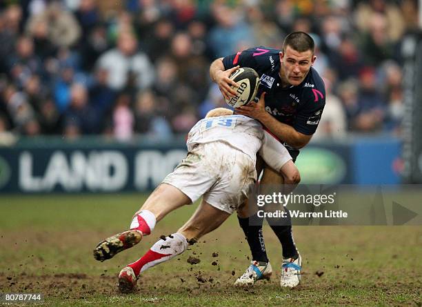 Chris Bell of Sale is tackled by Tom Dillion of Newcastle during the Guinness Premiership match between Sale Sharks and Newcastle Falcons at the...