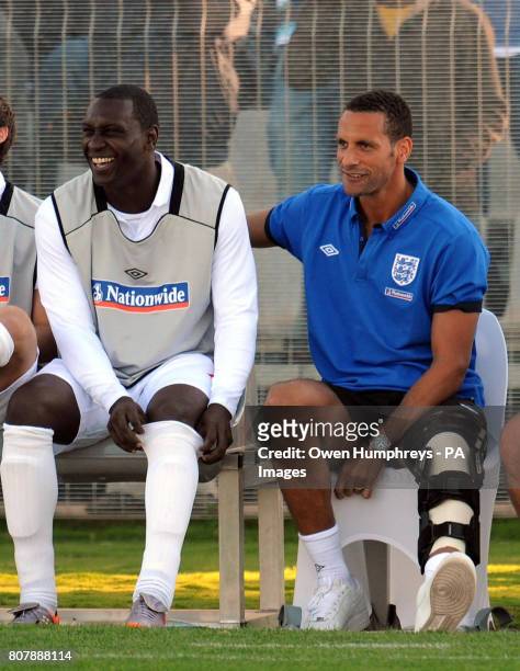 An injured Rio Ferdinand sits with Emile Heskey during the training match at Moruleng Stadium, Moruleng, South Africa.
