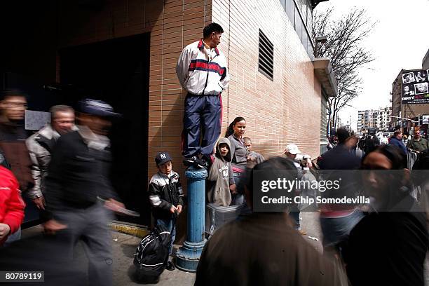 Man stands on a traffic stanchion to get a better view of Pope Benedict XVI as he arrives at Yankee Stadium to celebrate Mass April 20, 2008 in the...