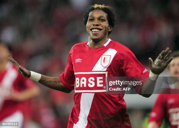 Standard's Congolese striker Dieumerci Mbokani celebrates after scoring against RSCA Anderlecht during their Belgian first division football match on...