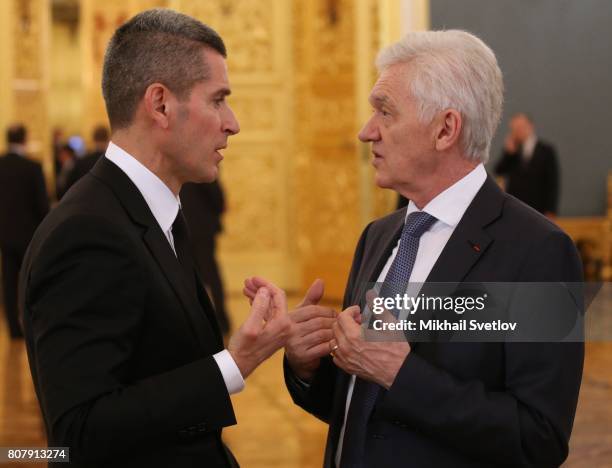 Russian businessman and billionaire Gennady Timchenko talks to Summa Group's CEO Ziyavudin Magomedov during Russia-China talks between Russian...