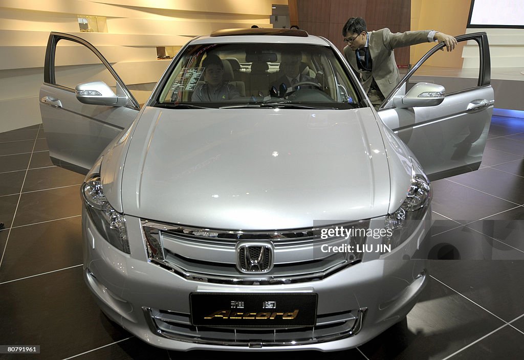 Visitors take a look at a car made by Ja