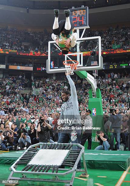 David Ortiz of the Boston Red Sox assists Lucky, the Boston Celtics mascot, with a dunk during Game One of the Eastern Conference Quarterfinals...