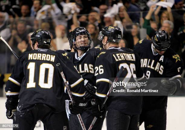 Defenseman Stephane Robidas celebrates a goal with Brenden Morrow, Jere Lehtinen and Mike Modano of the Dallas Stars against the Anaheim Ducks during...