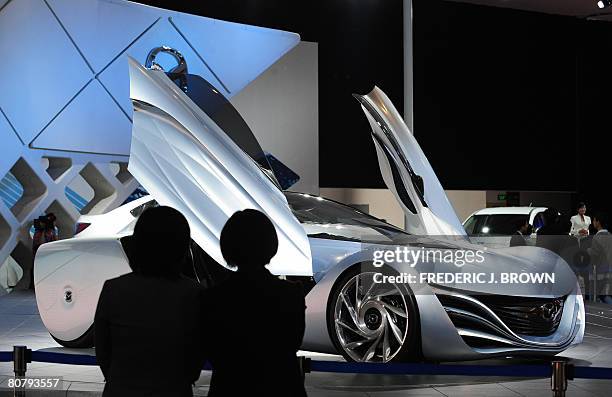 People view the Mazda concept car Taiki on display among crowds gathered at the Beijing Auto Show on April 21, 2008. The world's top car-makers are...