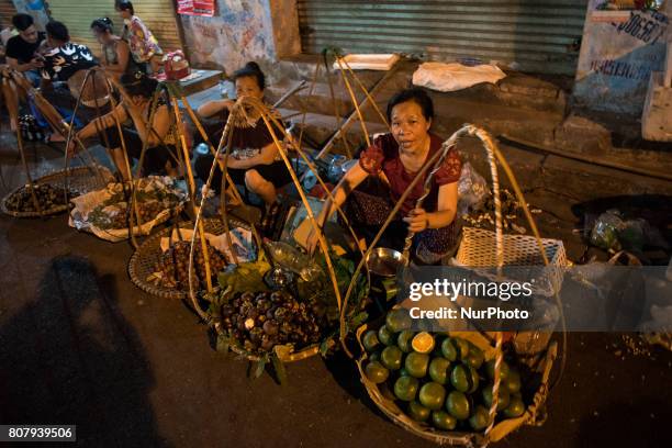 Fruit stands on a street in Hanoi, Vietnam, on 5 June 2017. In this city there is practically activity on the streets 24 hours a day. Hanoi, is the...