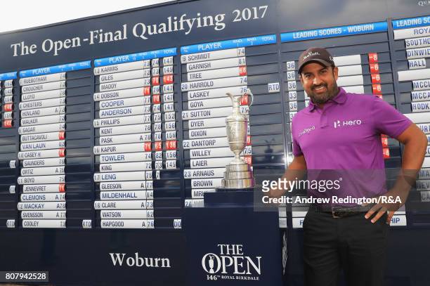 Shiv Kapur of India poses next to the claret jug after finishing at 8 under par during The Open Championship Final Qualifying at Woburn Golf Club on...