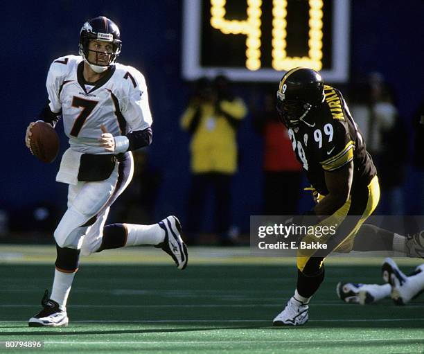 Hall of Fame quarterback John Elway of the Denver Broncos rolls out and looks for an open during the Broncos 24-21 victory over the Pittsburgh...
