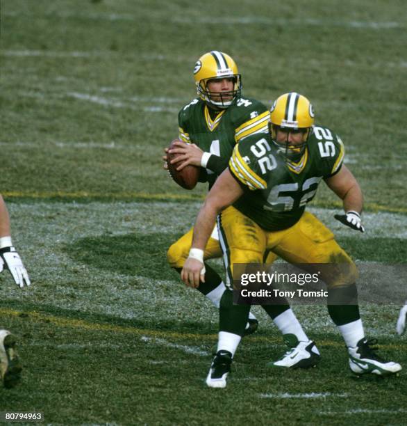 Green Bay Packers center Frank Winters protects quarterback Brett Favre as Favre drops back to pass during the NFC Championship Game, a 30-13 victory...