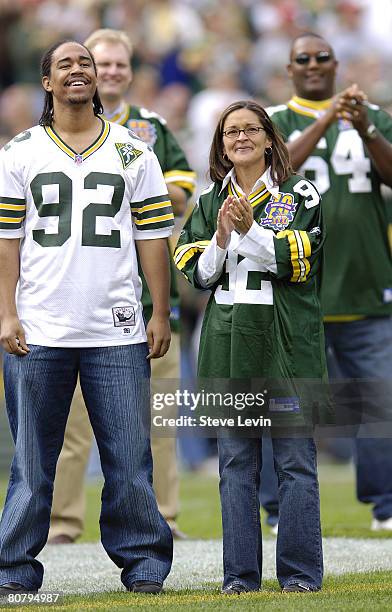 Sarah White, wife of Reggie White, and son Jeremy watch the unveiling of Reggie's name on the inside of the inside of the stadium before the game...