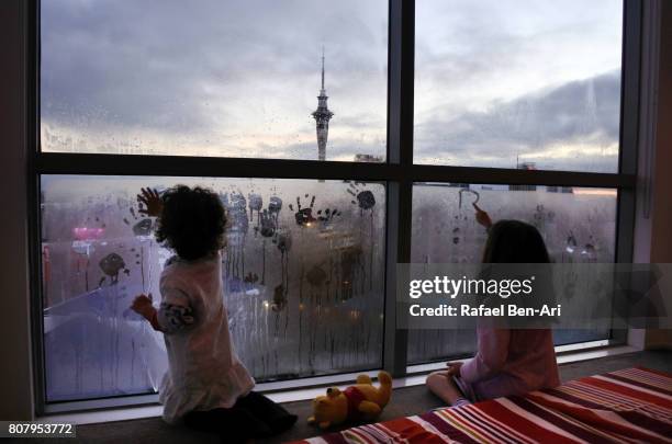 girls drawing early morning art on window condensation - condensation drawing stock pictures, royalty-free photos & images