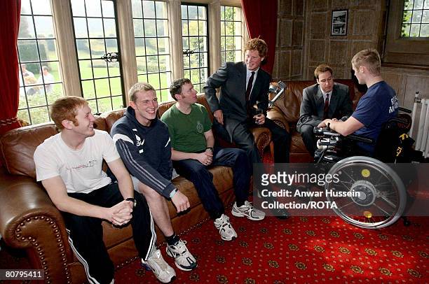 Prince William and Prince Harry speak with , Lance Corporal James Bleach of 14th Signals Regiment, Lance Sergeant Adam Ball from 1st Battalion...
