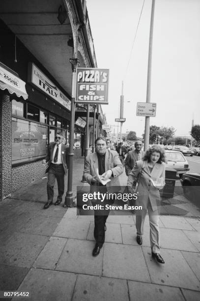 Labour Party politician John Prescott eats take-away fish and chips in the street during a visit to Cleethorpes, August 1996. With him is Shona...