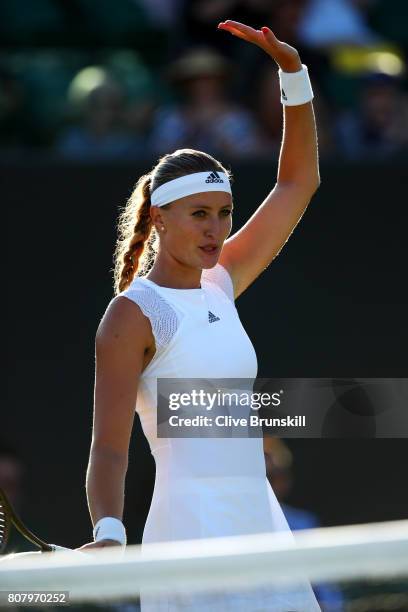 Kristina Mladenovic of France acknowledges the crowd as she celebrates victory after the Ladies Singles first round match against Pauline Parmentier...