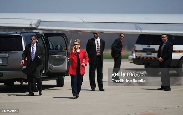 Democratic presidential hopeful U.S. Senator Hillary Clinton speaks on the phone as she waits to get on her plane at the Scranton airport after...