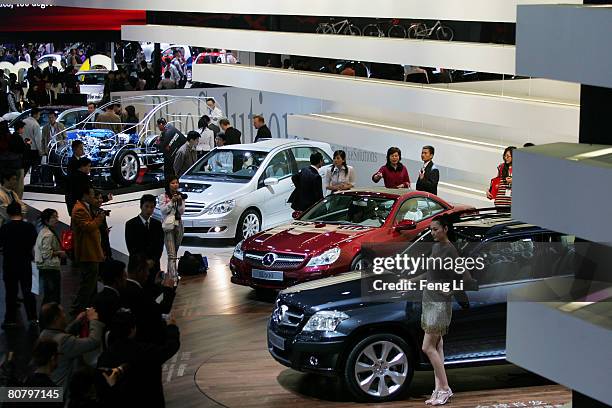 Model poses beside the Mercedes-Benz GLK 280 during a special media opening of the Auto China 2008 show at the new China International Exhibition...
