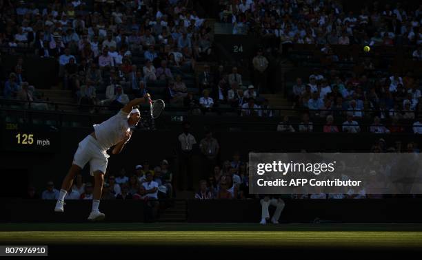 Austria's Dominic Thiem serves to Canada's Vasek Pospisil during their men's singles first round match on the second day of the 2017 Wimbledon...
