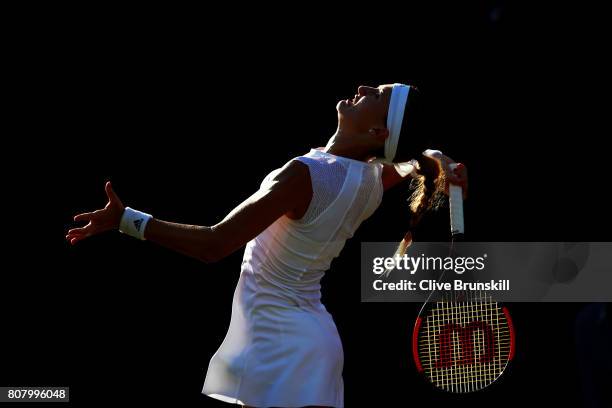 Kristina Mladenovic of France serves during the Ladies Singles first round match against Pauline Parmentier of France on day two of the Wimbledon...