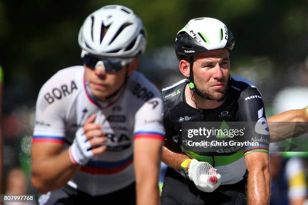 Mark Cavendish of Great Britain riding for Team Dimension Data rides in next to Juraj Sagan of Slovakia riding for Bora-Hansgrohe following stage...