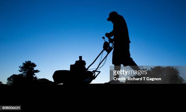 Salem Country Club grounds department employee Bob Bowden mows the collar on the 11th green before the first practice round of the 2017 US Senior...