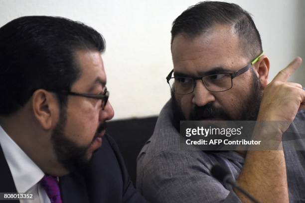 Javier Duarte , former governor of the Mexican state of Veracruz, accused of graft and involvement in organized crime, speaks with his lawyer Carlos...