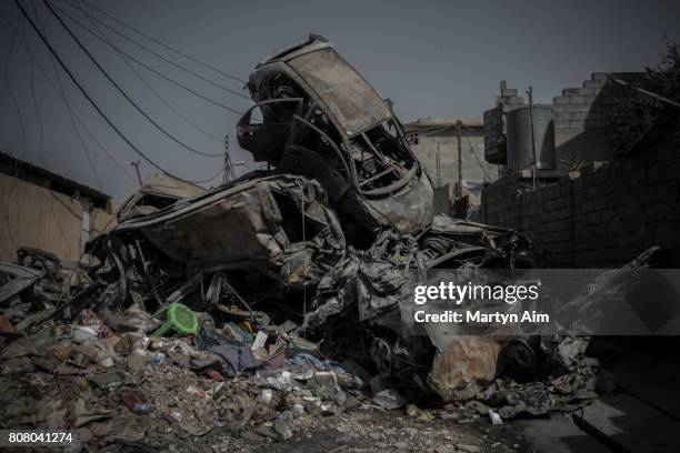 Pile of cars destroyed in airstrikes in a street in west Mosul on July 4, 2017 in Mosul, Iraq. Iraqi forces continue to encounter stiff resistance in...