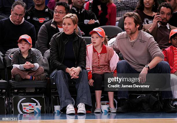 A Leoni and David Duchovny with their children attend Minnesota Timberwolves vs NY Knicks basketball game at Madison Square Garden in New York City...