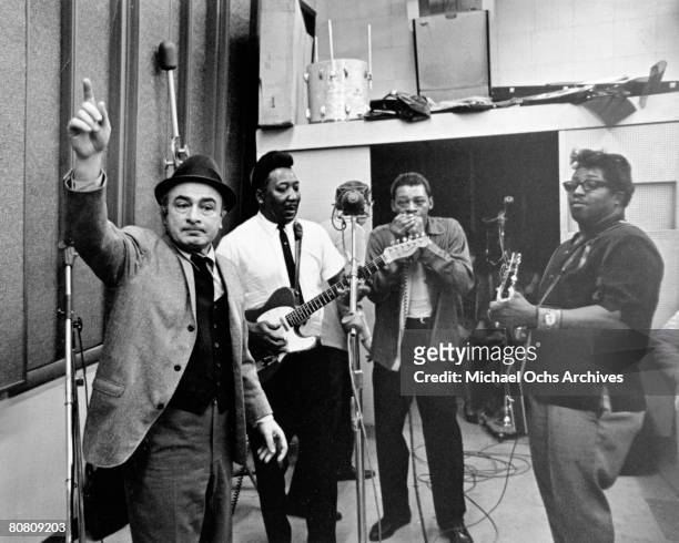 Chess Records co-founder Phil Chess supervises the recording of Chess artists (L-R: Muddy Waters, Little Walter and Bo Diddley as they record the...