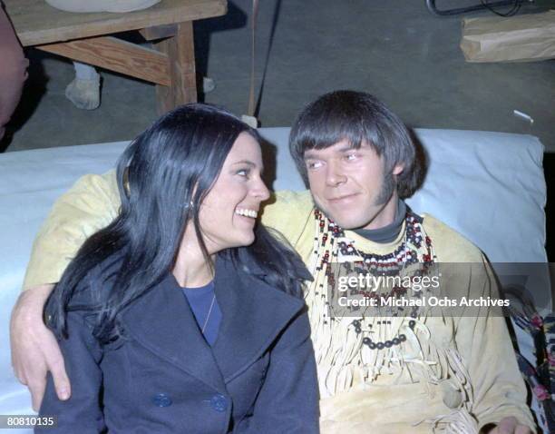 Singer/Songwriter Neil Young of the group Buffalo Springfield poses for a portrait with a woman at Gold Star Recording Studios in 1966 in Los...