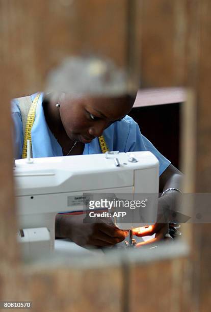 Young girl makes a uniform on a sowing machine donated by international organizations to people displaced by violence, on April 18 at Pedro Grau...