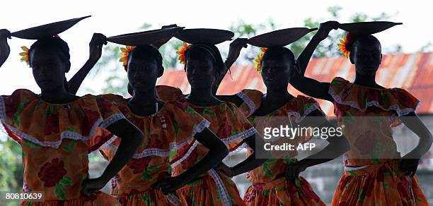 Young girls perform in a dance show to celebrate a donation made by an NGO to people displaced by violence at Pedro Grau school in Quibdo, department...