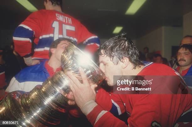 Canadian ice hockey player Guy Carbonneau of the Montreal Canadiens drinks from the Stanley Cup following his team's victory over the Calgary Flames,...