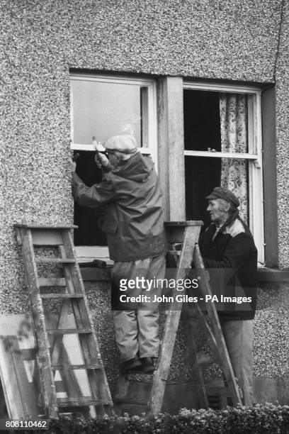 Workmen repair damaged windows in Lockerbie, which were shattered when a Pan Am Boeing 747 was bombed and crashed into the small town, killing all...