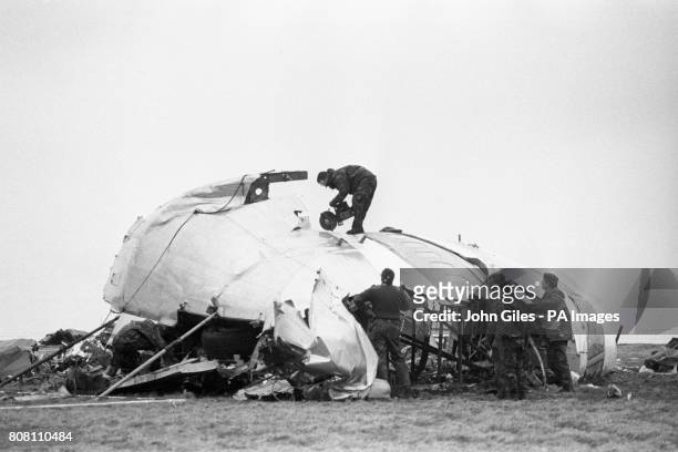 The cockpit section of the bombed Pan Am Boeing 747 being cut into pieces before being removed by transporter from the disaster site.